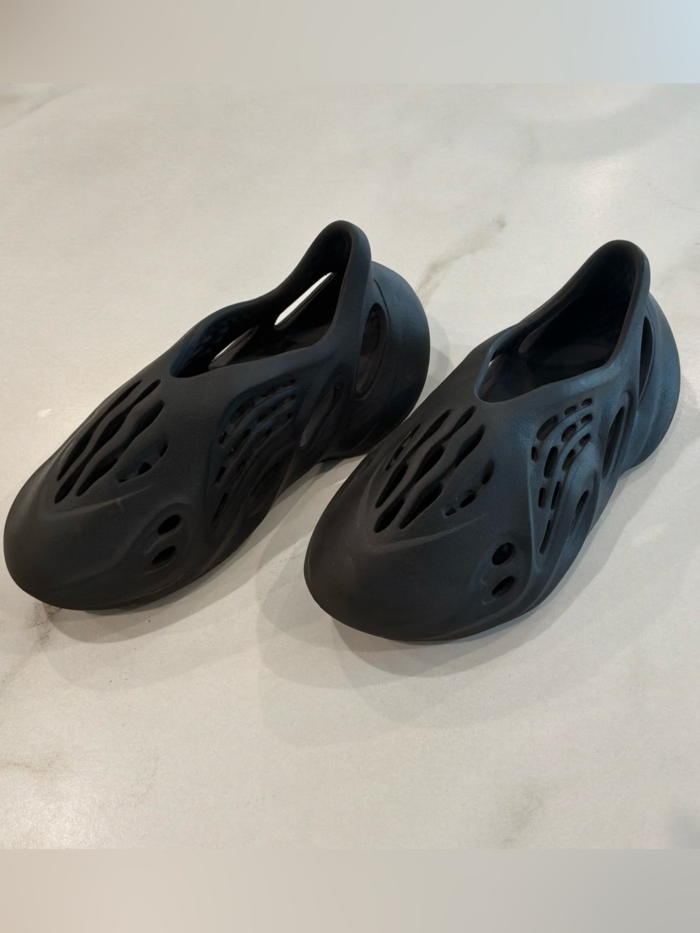 adidas Yeezy Foam Runner 'slides.   
 Kids Black Foam Slip-On Clog